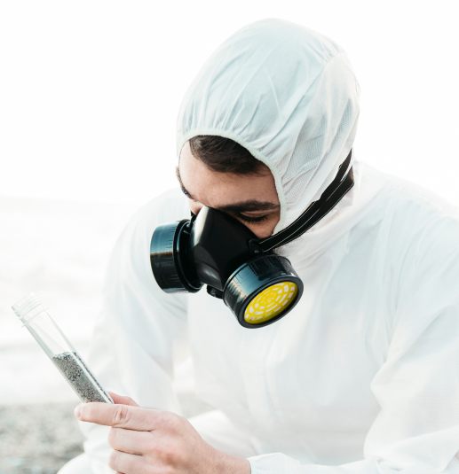 Inspector with respirator examining sample