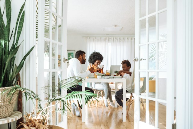 Family sharing a meal at home in a bright dining room Family sharing a meal at home in a bright dining room